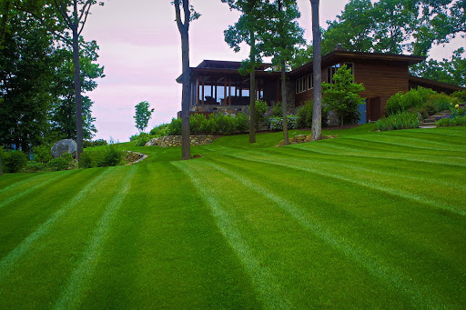 A finely mowed lawn around a residential property