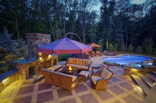 backyard patio seating arrangement next to pool