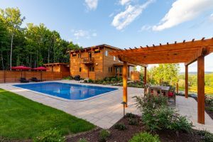 beautiful luxury pool with pergola and outdoor kitchen