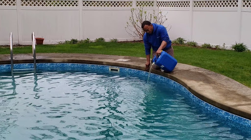 Man Pouring Chlorine into Swimming Pool