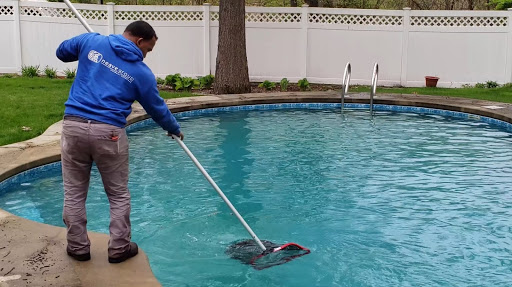 Man Working With Pool Skimmer Net