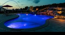Illuminating pool with blue lighting and sunset