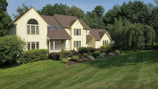 Light beige house with large lawn