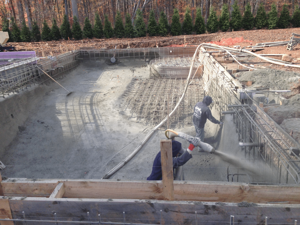 Pool construction involves installing a steel rebar cage and shooting gunite, or installing vinyl pool walls