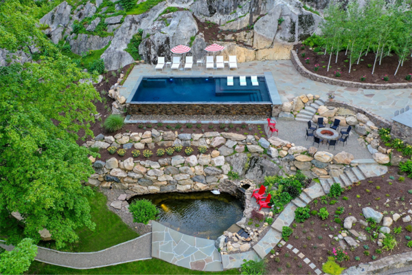 Backyard pool with rockwall and beautiful nature landscape