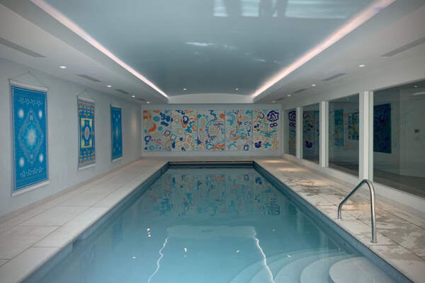 Minimalist indoor pool with murals