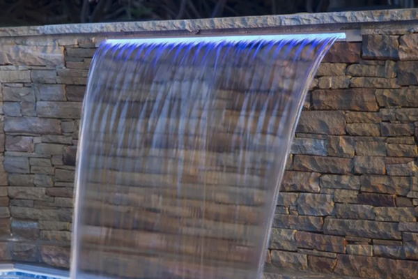 A mesmerizing pool featuring sheer descent waterfalls as stunning water features