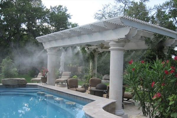 A refreshing swimming pool with stay cool misters as a invigorating water feature