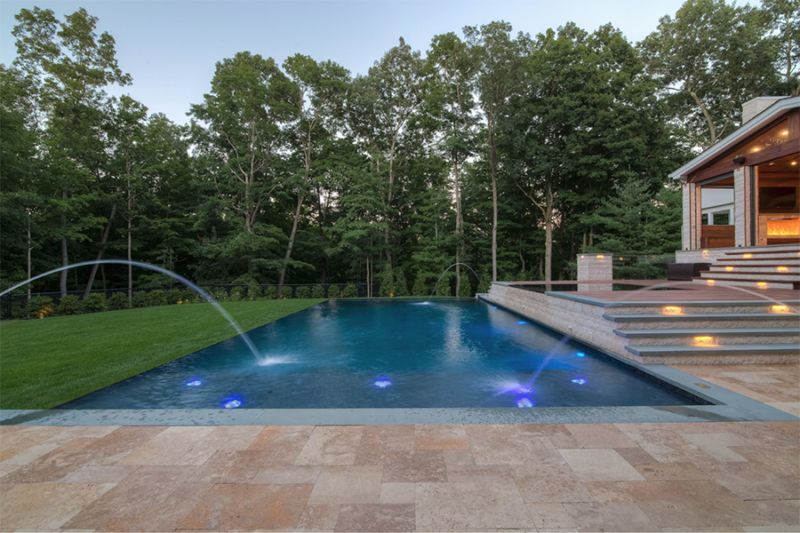 An elegant pool oasis with enchanting lighting creating a captivating ambiance concept image of water features for swimming pool