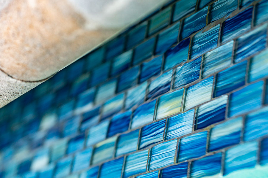 Close-up view of meticulously placed pool tiles reflecting the high-quality work of New York, New Jersey, and Connecticut swimming pool refinishing services.