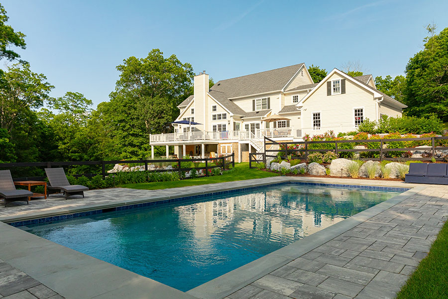 Spacious rectangular pool adjacent to a comfortable outdoor seating area, exemplifying Neave Group’s ability to match pool size and depth to homeowner needs and ensure quality material use.