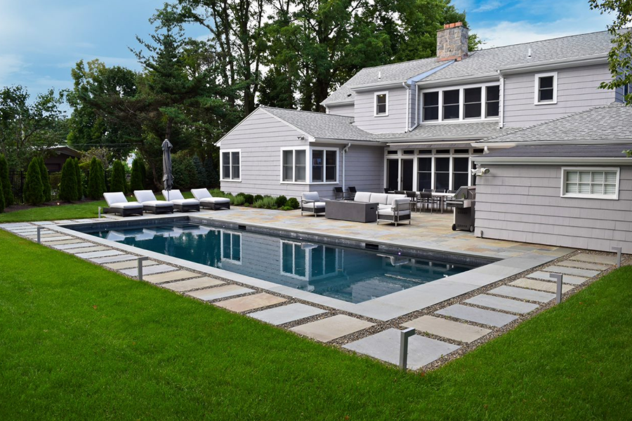 sustainable landscaping features, including native plants and stone pathways around a rectangular pool